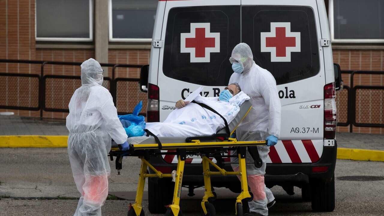 Emergency workers transport a patient in Leganes, Spain,