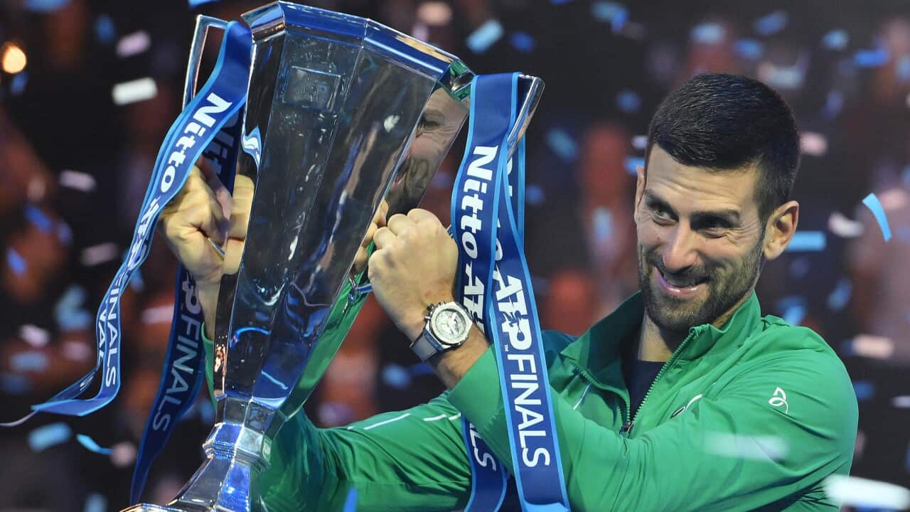 Novak Djokovic of Serbia poses with the trophy after winning his singles finals match against Jannik Sinner of Italy at the Nitto ATP Finals tennis tournament in Turin