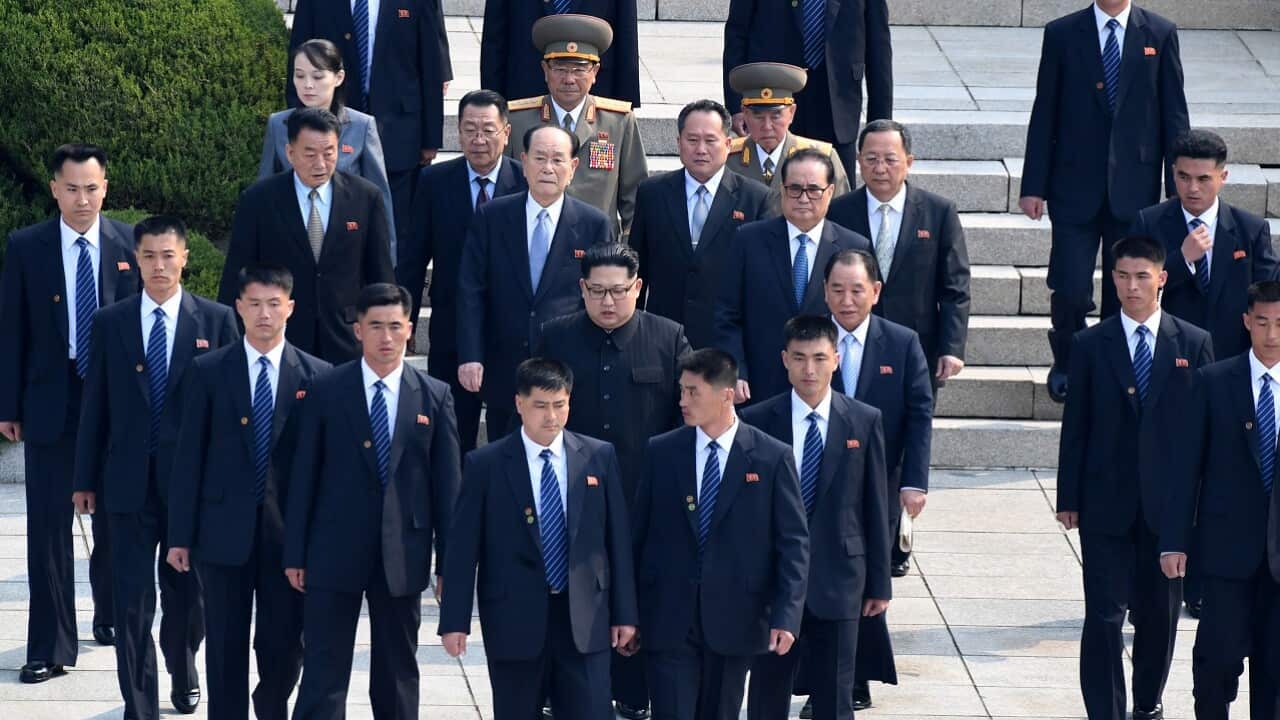 North Korea's leader Kim Jong-un is escorted by bodyguards as he walks from the North to the Military Demarcation Line ahead of the Inter-Korean summit.