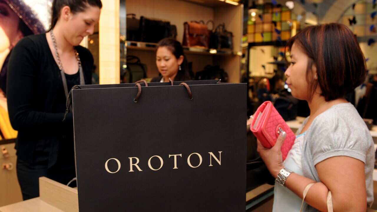 A customer purchases a product at an Oroton store in Sydney