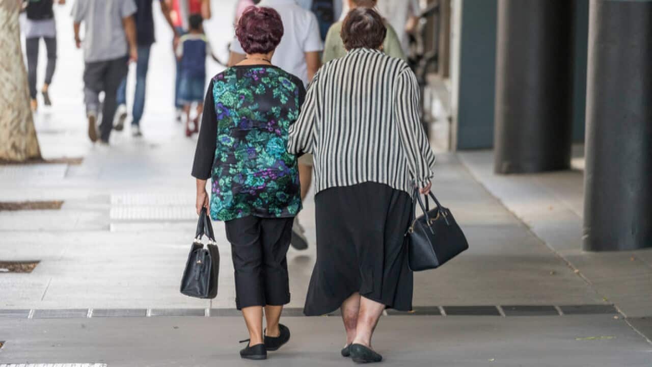 Elderly people walk in the street, in Brisbane, Saturday, May 5, 2018. (AAP Image/Glenn Hunt) NO ARCHIVING