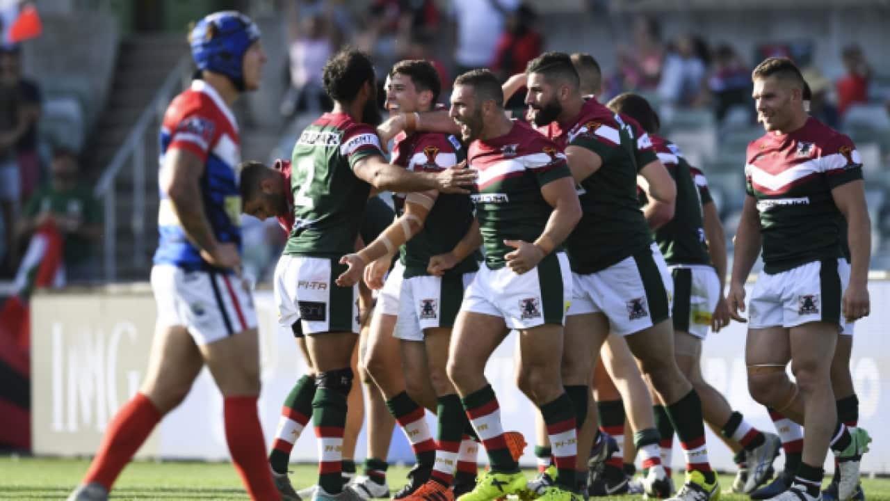 Mitchell Moses of Lebanon celebrates with team mates after scoring a try