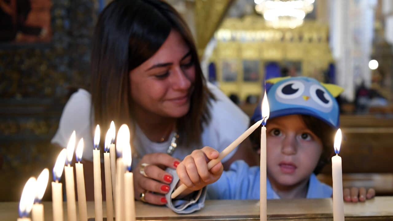 Lebanese Orthodox Christians light candles as they celebrate the traditional Palm Sunday mass at the Saint George Cathedral in downtown Beirut.
