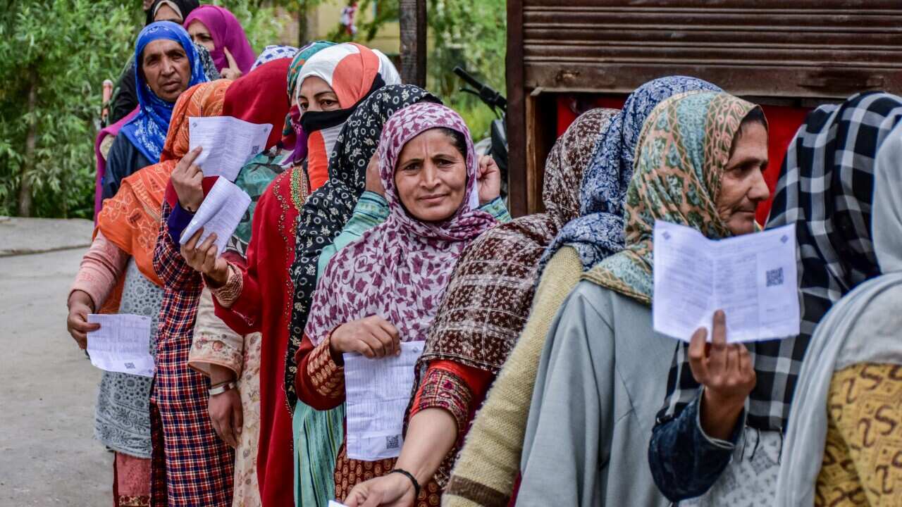 Kashmiri voters queue up to cast their ballots at a polling station, during the fourth general election phase.