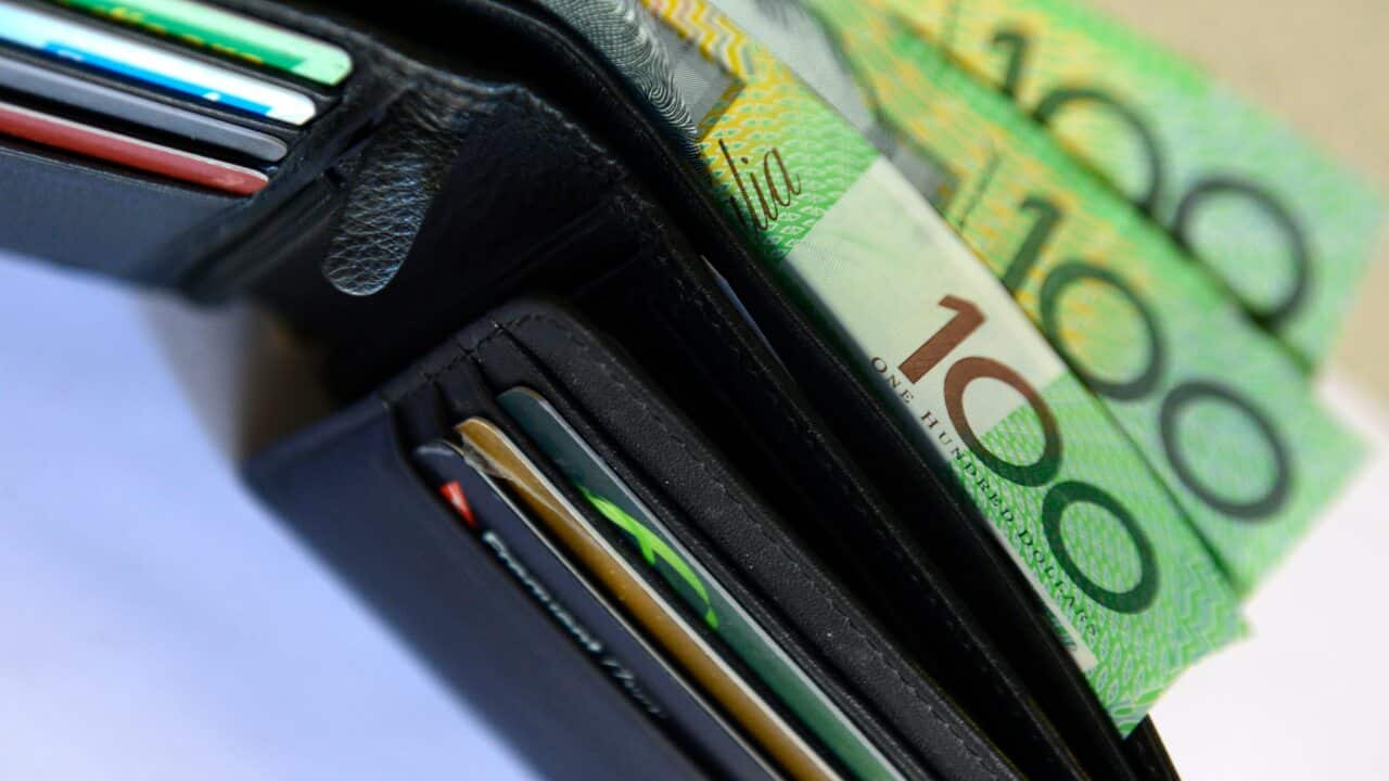 $100 Australian dollar notes pop out of a wallet with credit cards, pictured in Brisbane, Tuesday, Aug. 20, 2013. (AAP Image/Dan Peled) NO ARCHIVING