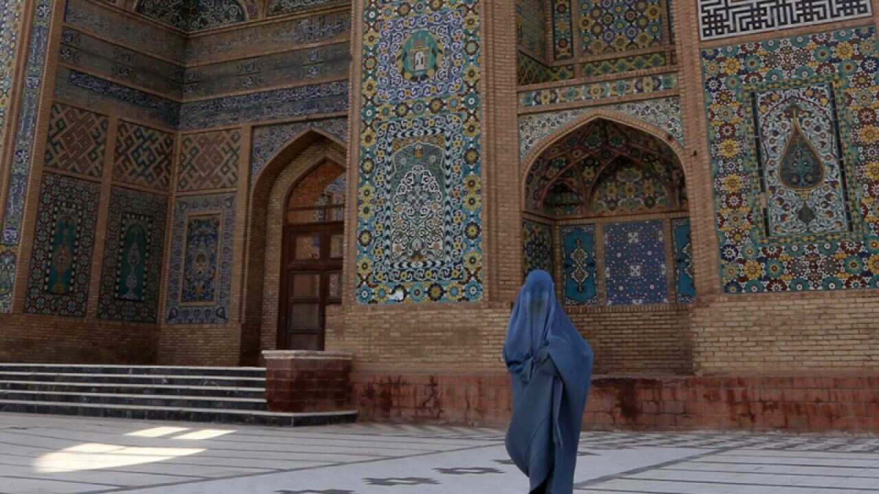 An Afghan women wearing traditional dress
