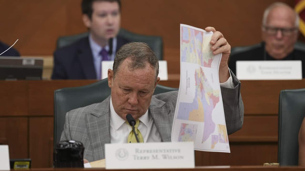 Texas state Representative Terry M. Wilson looks through maps during a public hearing on congressional redistricting in Austin, Texas.