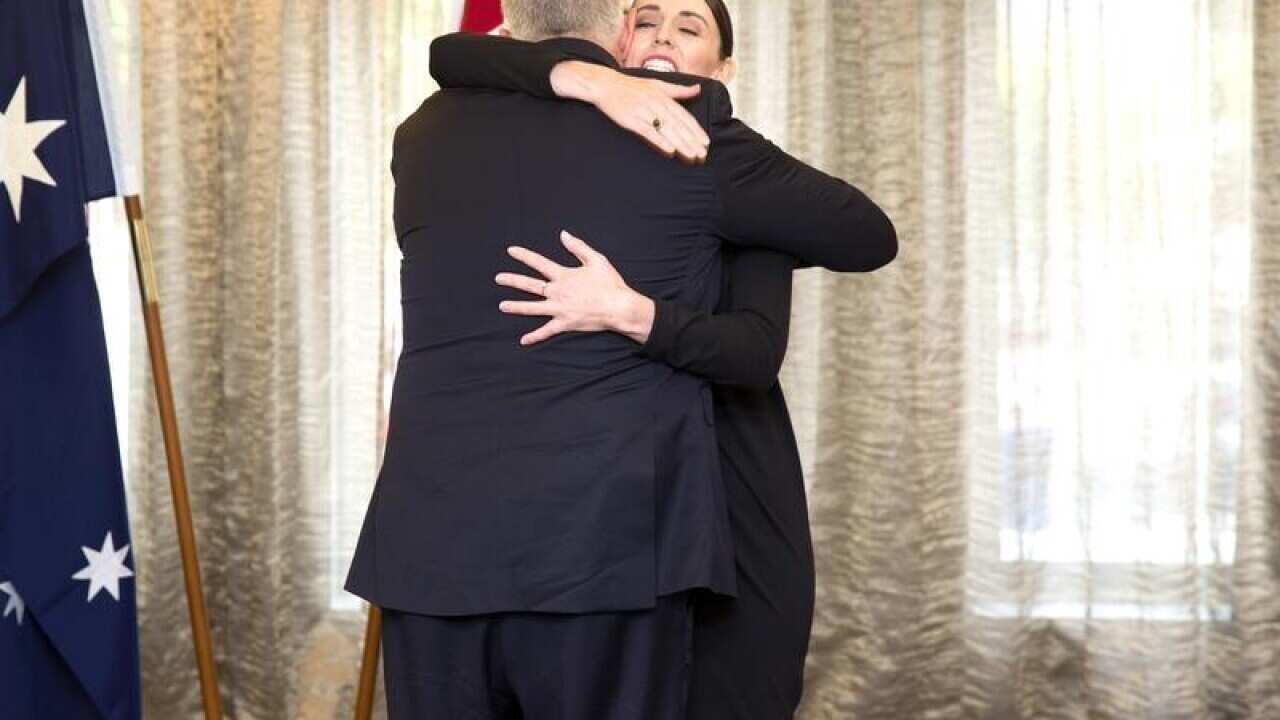 Australian PM Scott Morrison and New Zealand PM Jacinda Ardern hug a