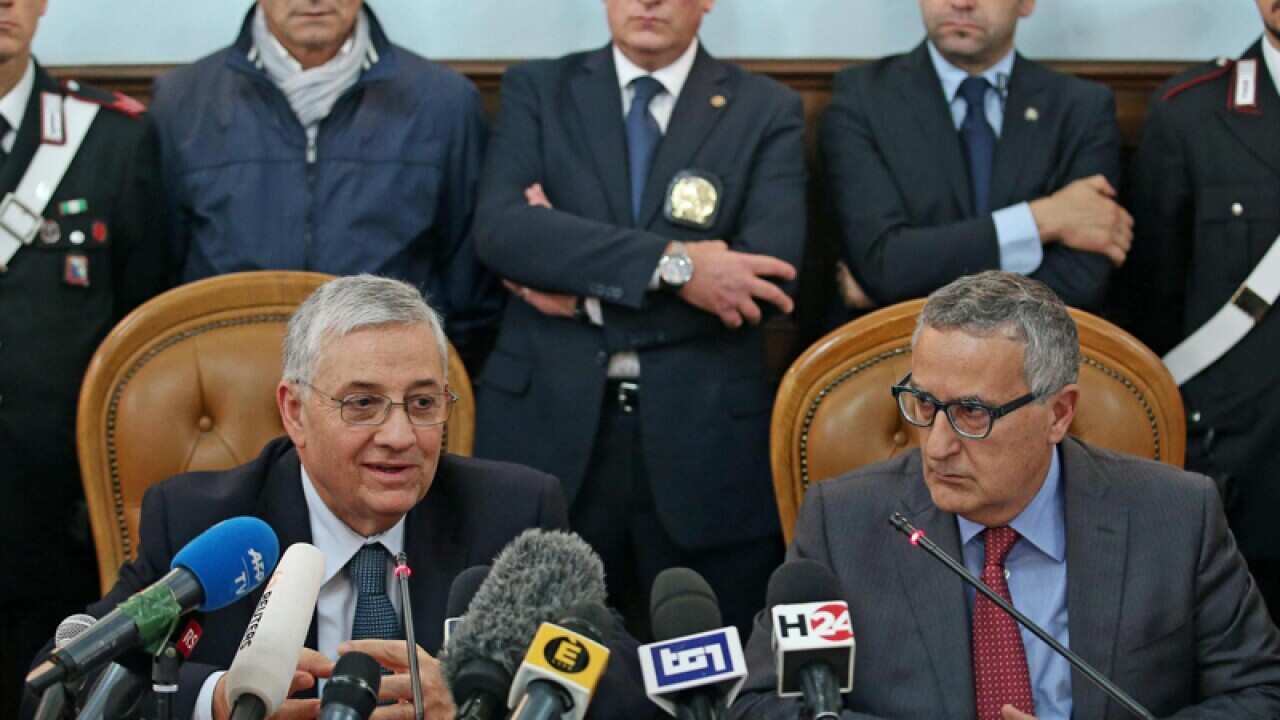 Italian authorities following an anti-terror operation