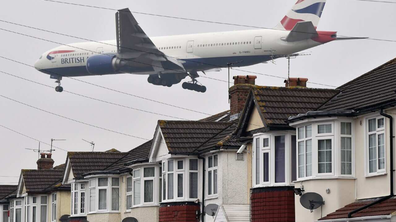 A British Airways airplane over houses close to Heathrow airport
