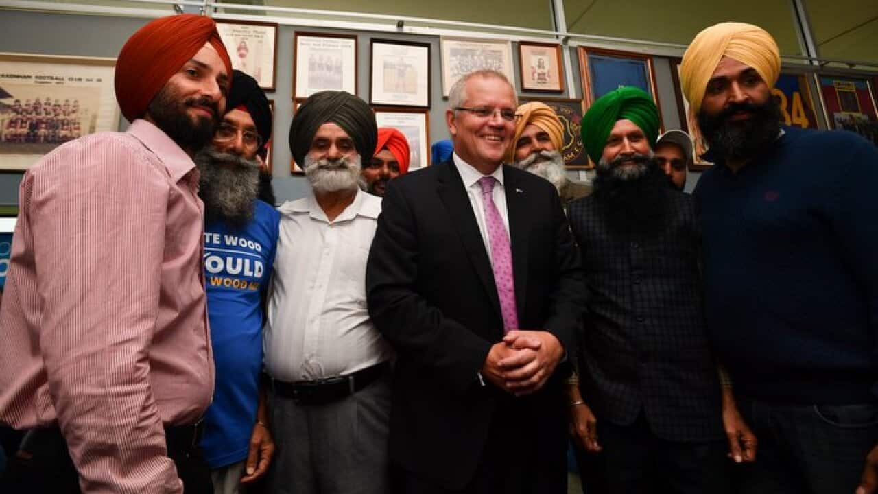 Prime Minister Scott Morrison with members of the Sikh community at the Pakenham Football Club in Melbourne, Monday, April 22, 2019. (AAP Image/Mick Tsikas) NO ARCHIVING