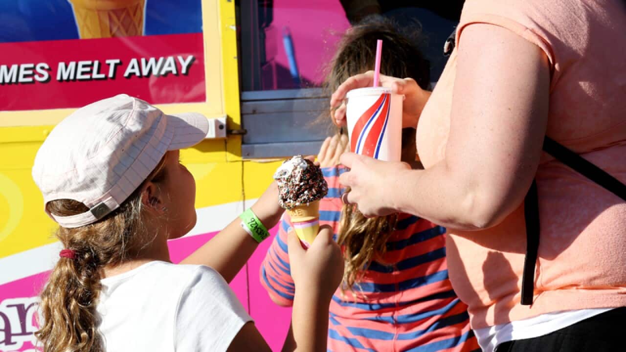 People eating sweet food at the Sydney Royal Easter Show