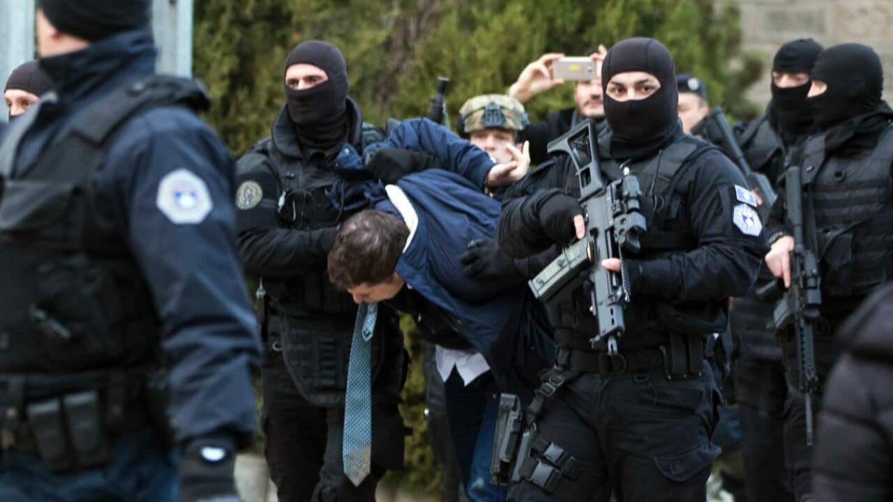 Kosovo police escort Marko Djuric a Serb official to a police station in the Kosovo capital Pristina 