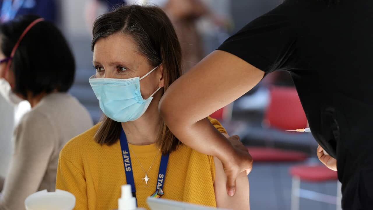 A woman is seen receiving her COVID-19 vaccination in Melbourne.