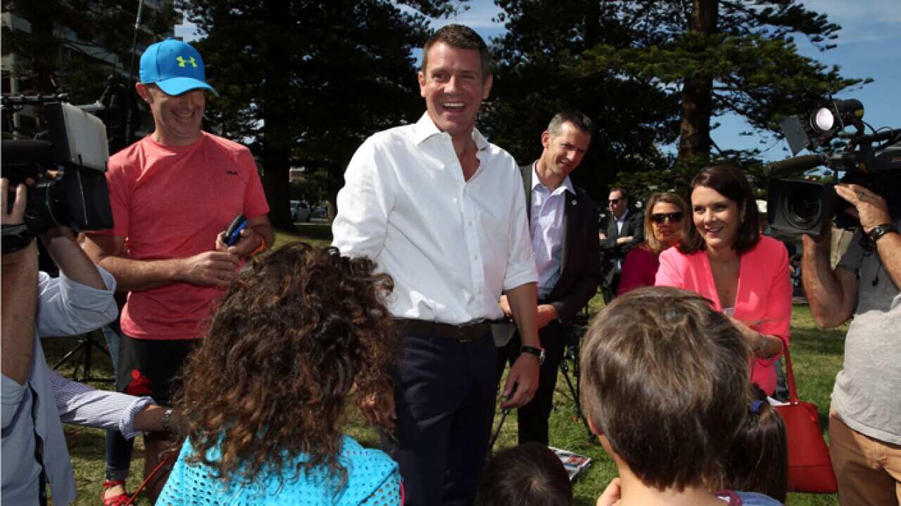 NSW Premier Mike Baird greets well wishers at Manly the day after winning the state election. 