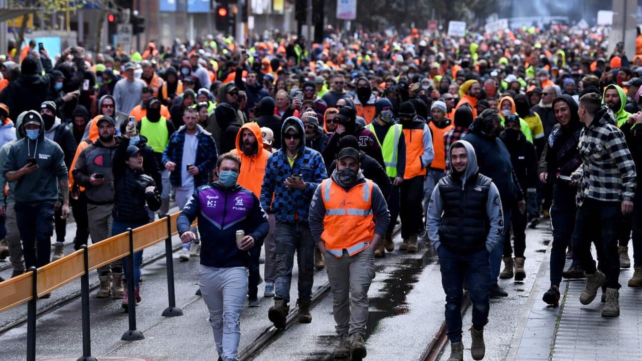 Construction workers are seen at a protest at Construction, Forestry, Maritime, Mining and Energy Union (CFMEU) headquarters in Melbourne, Tuesday, September 21, 2021. (AAP Image/James Ross) NO ARCHIVING