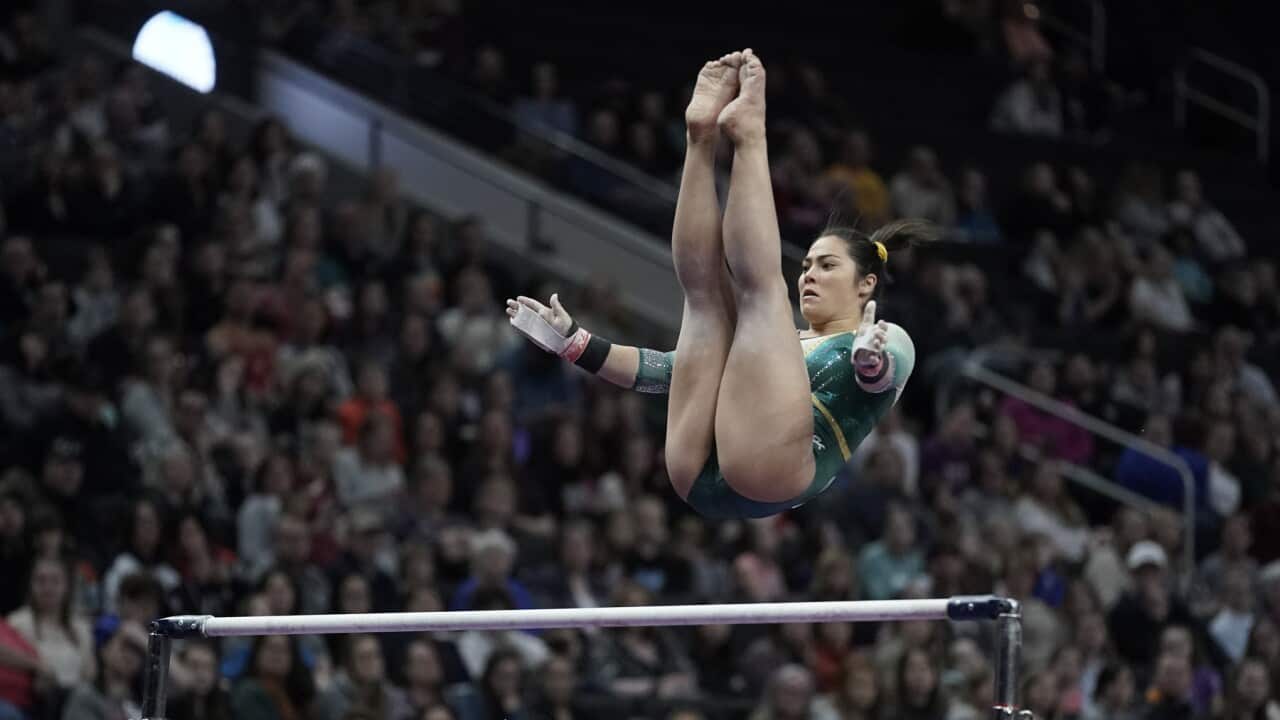 Georgia Godwin of Australia performs on the bars
