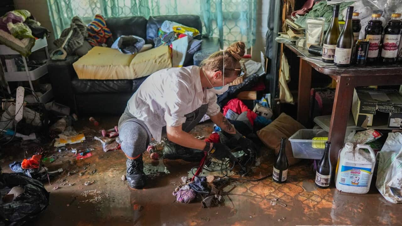 Volunteers help clean up a flooded home in Stratford, Cairns