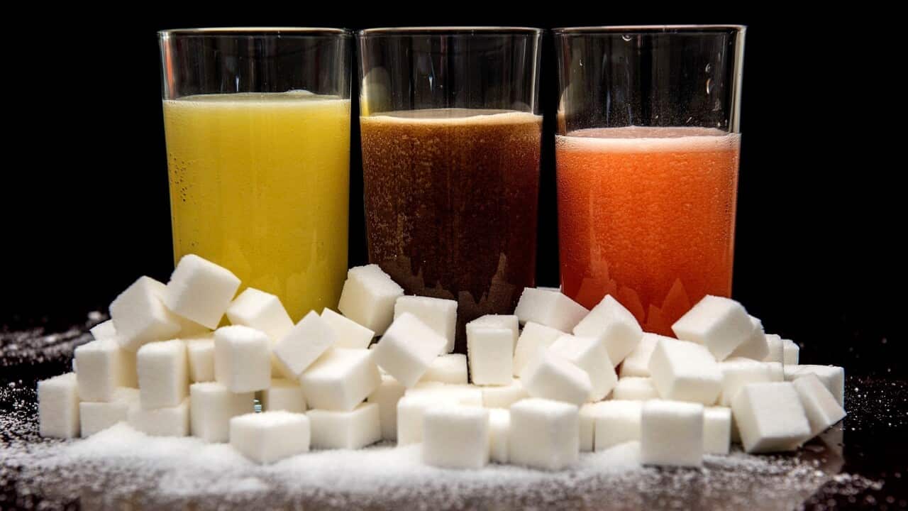soft drinks surrounded by sugar cubes.