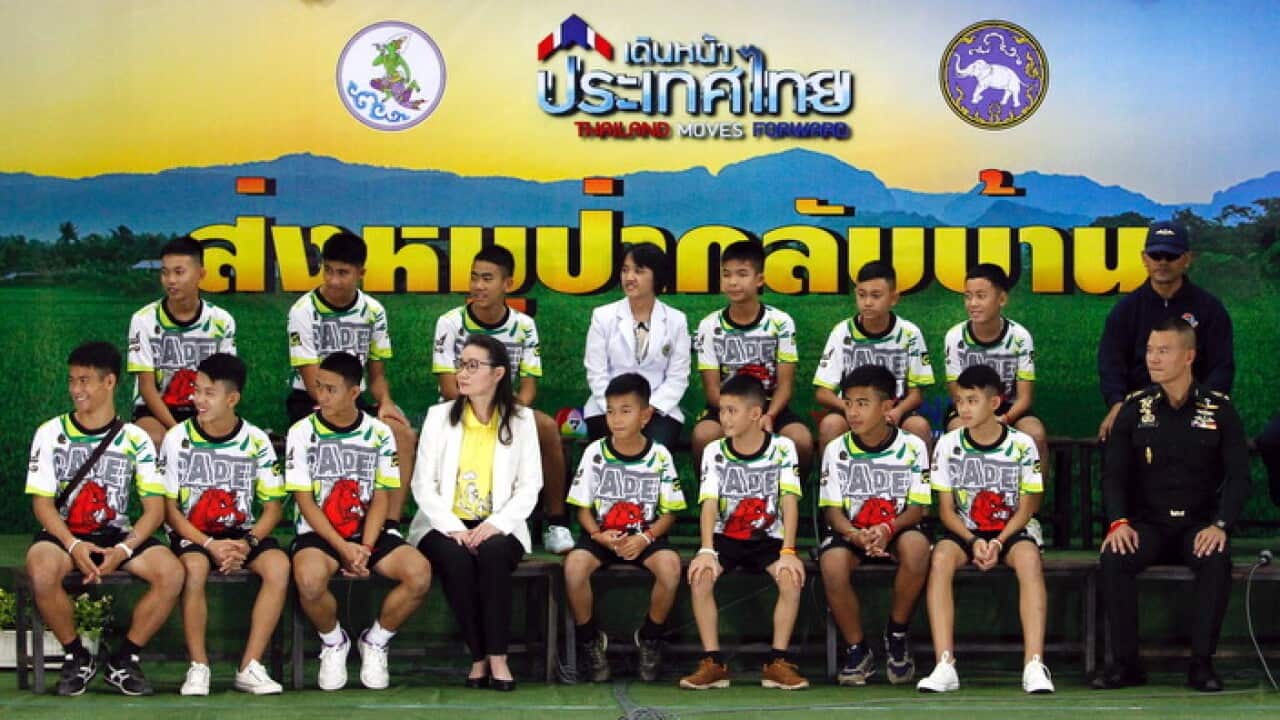 The 12 rescued members of the Wild Boar soccer team, with their assistant coach Ekapol Chantawong (front row, L)