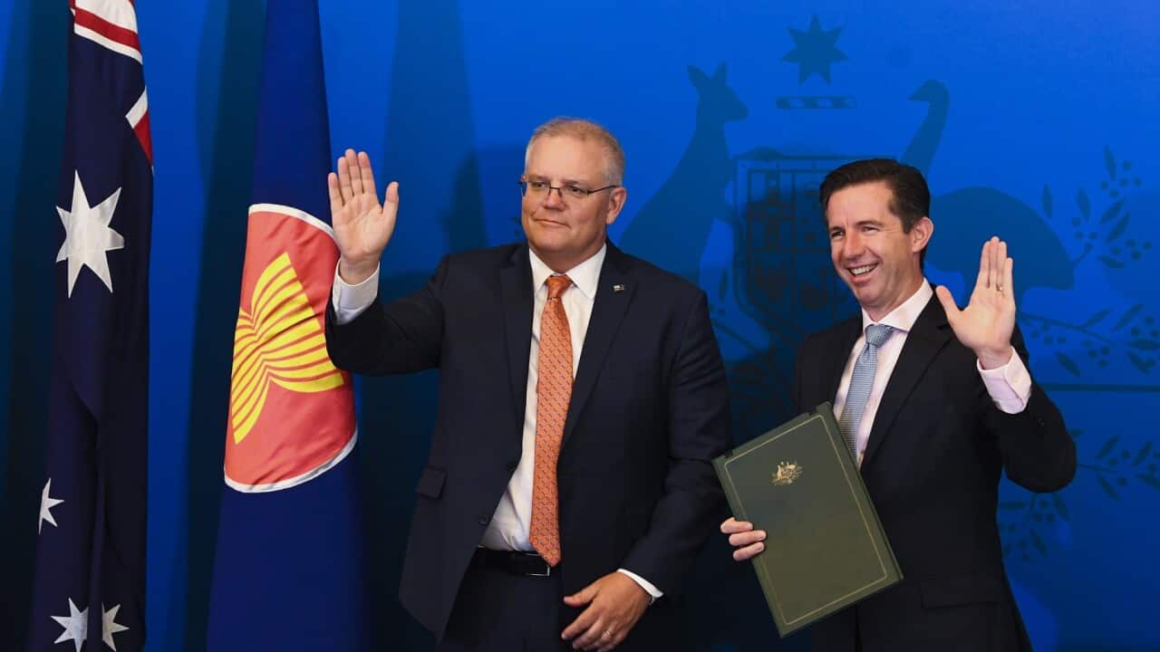 Australian Trade Minister Simon Birmingham (right) and Australian Prime Minister Scott Morrison react after signing the Regional Comprehensive Economic Partnership (RCEP).