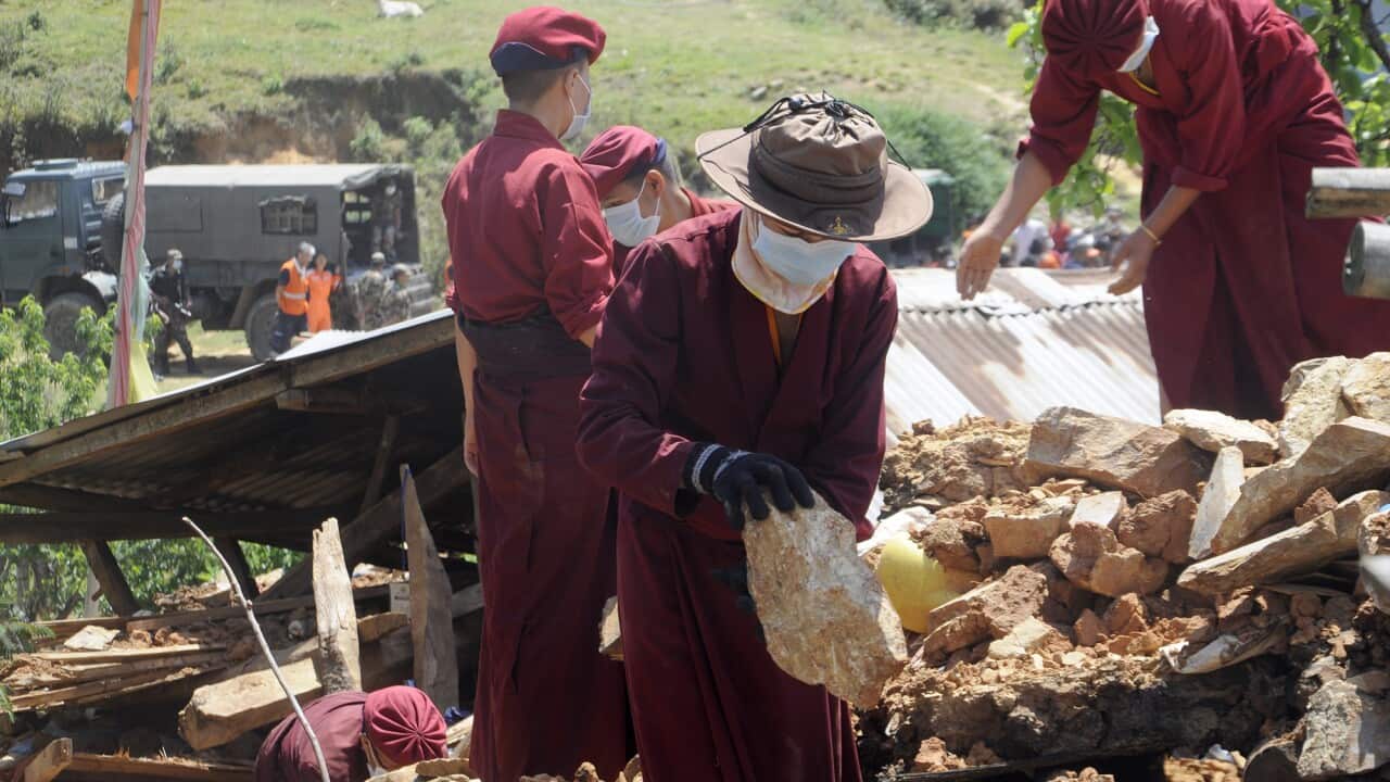 'Kung fu nuns' of Kathmandu remove the rubble in the nearby Kalabari village devastated by the deadly earthquake that hit Nepal. May 2, 2015 (Pradeep Bashyal/The Washington Post)