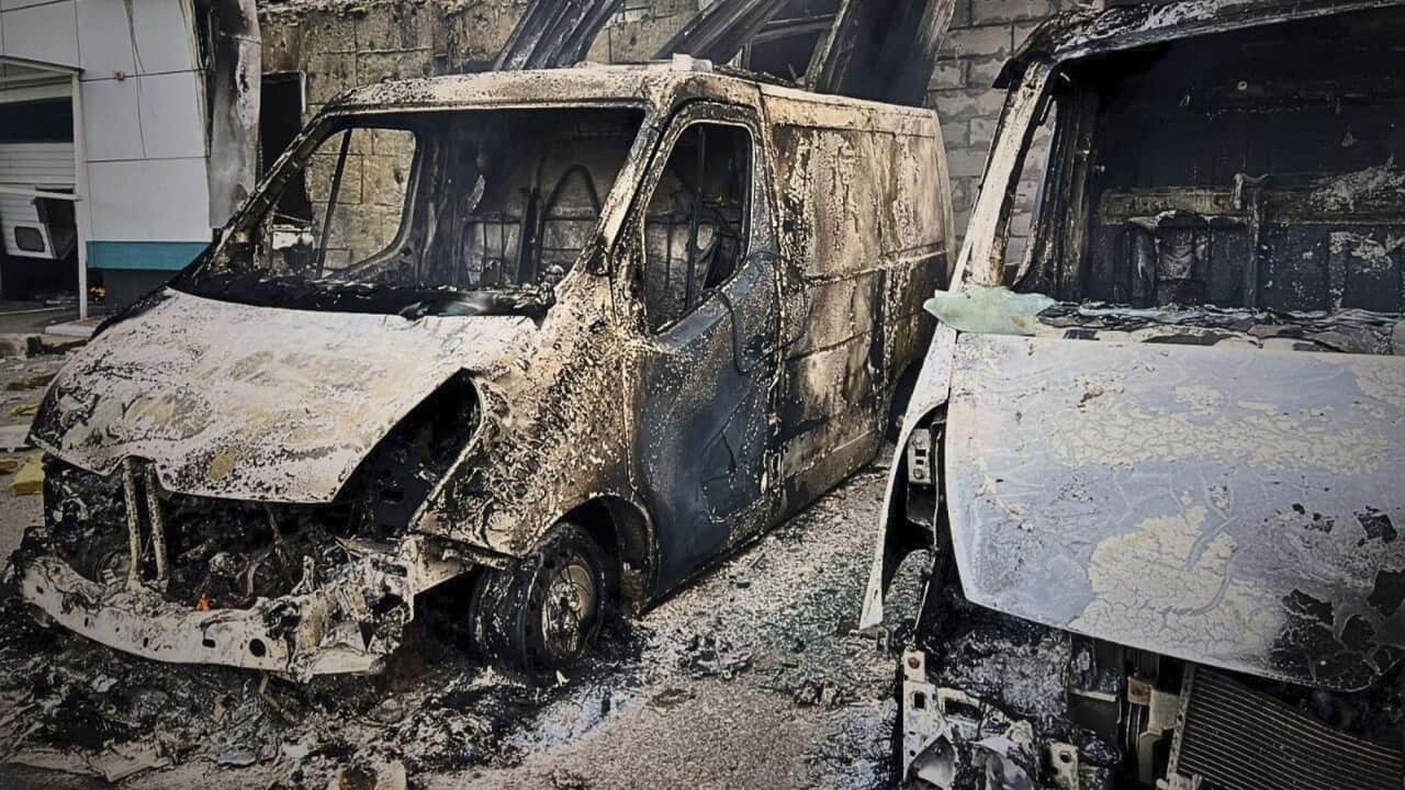 A van that has been heavily damaged by fire.