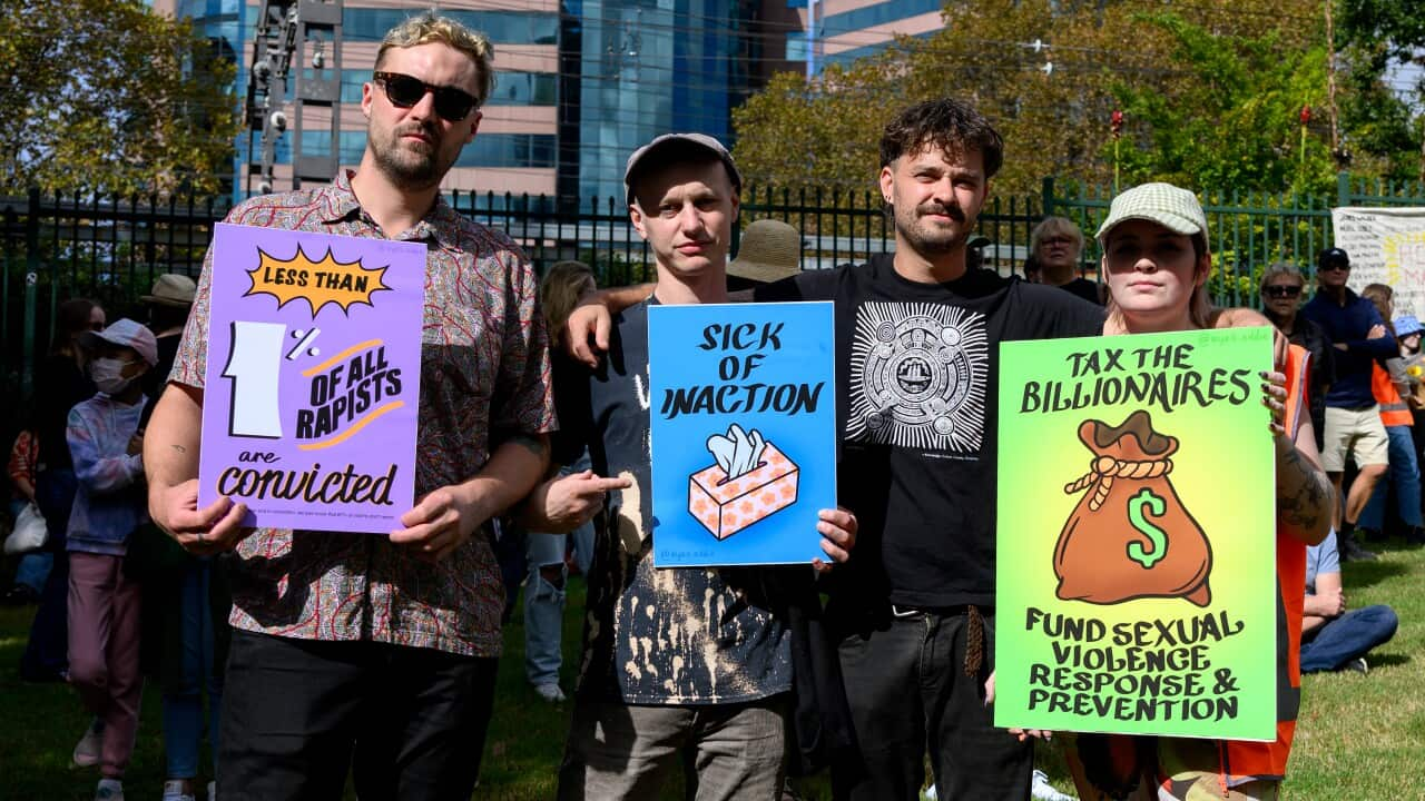 Men holding signs during a protest.