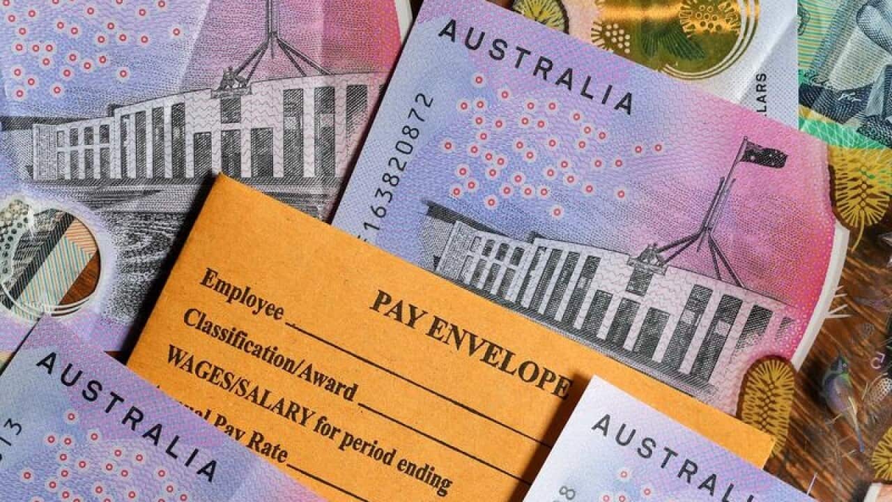 A stock photograph of Australian currency and a wages envelope.
