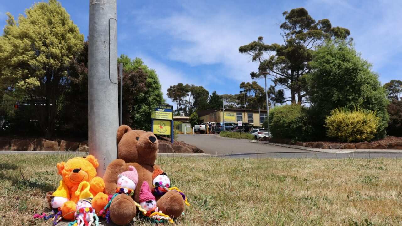 Flowers and tributes are seen outside Hillcrest Primary School in Devonport, Tasmania, Friday, 17 December, 2021.