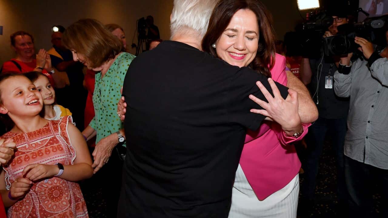 Queensland Premier Annastacia Palaszczuk (right) hugs her father Henry Palaszczuk after winning the Queensland State election.