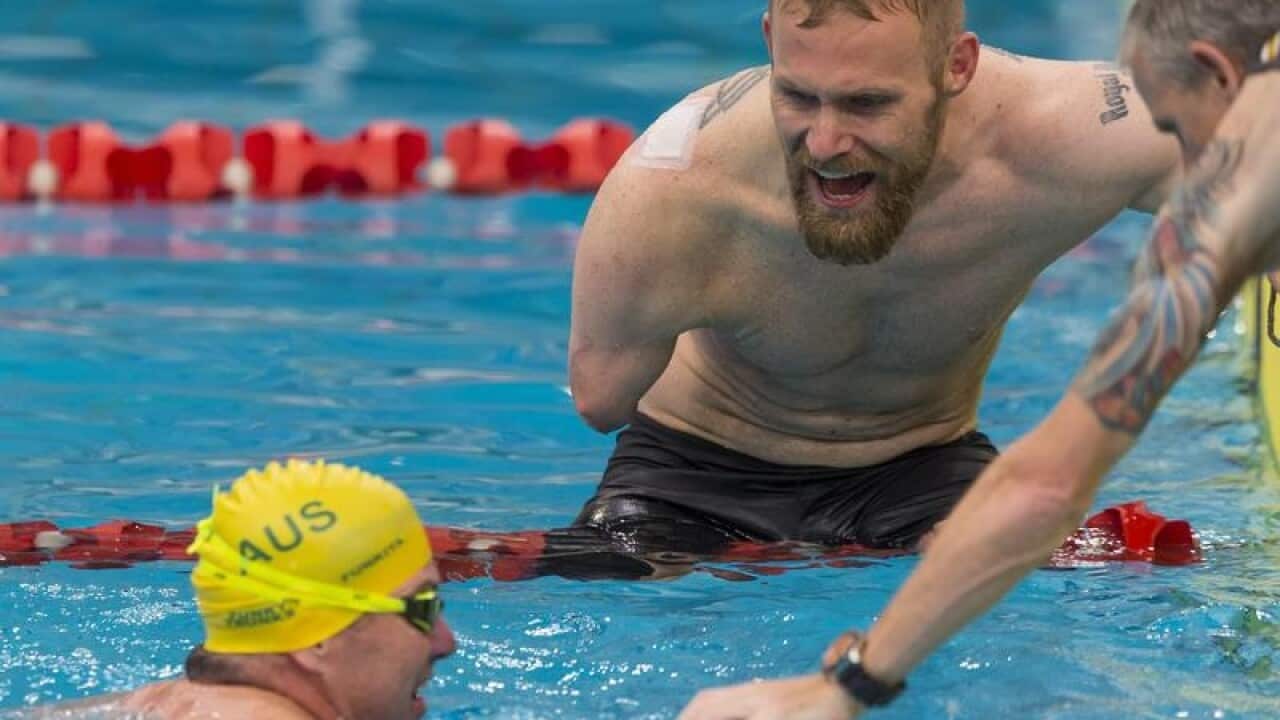 Mark Ormrod of the UK encourages Australia's Garry Robinson.