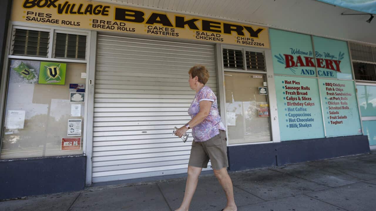 A woman walks past the Box Village Bakery in Sylvania.