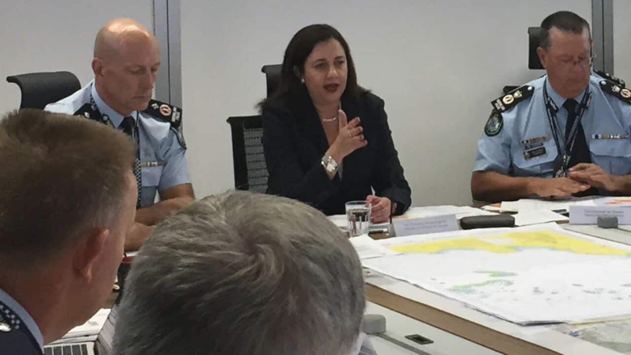 QLD Premier Annastacia Palaszczuk (centre) speaks during a meeting