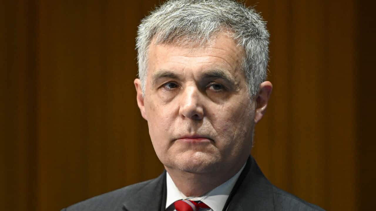 A man wearing a suit and tie.