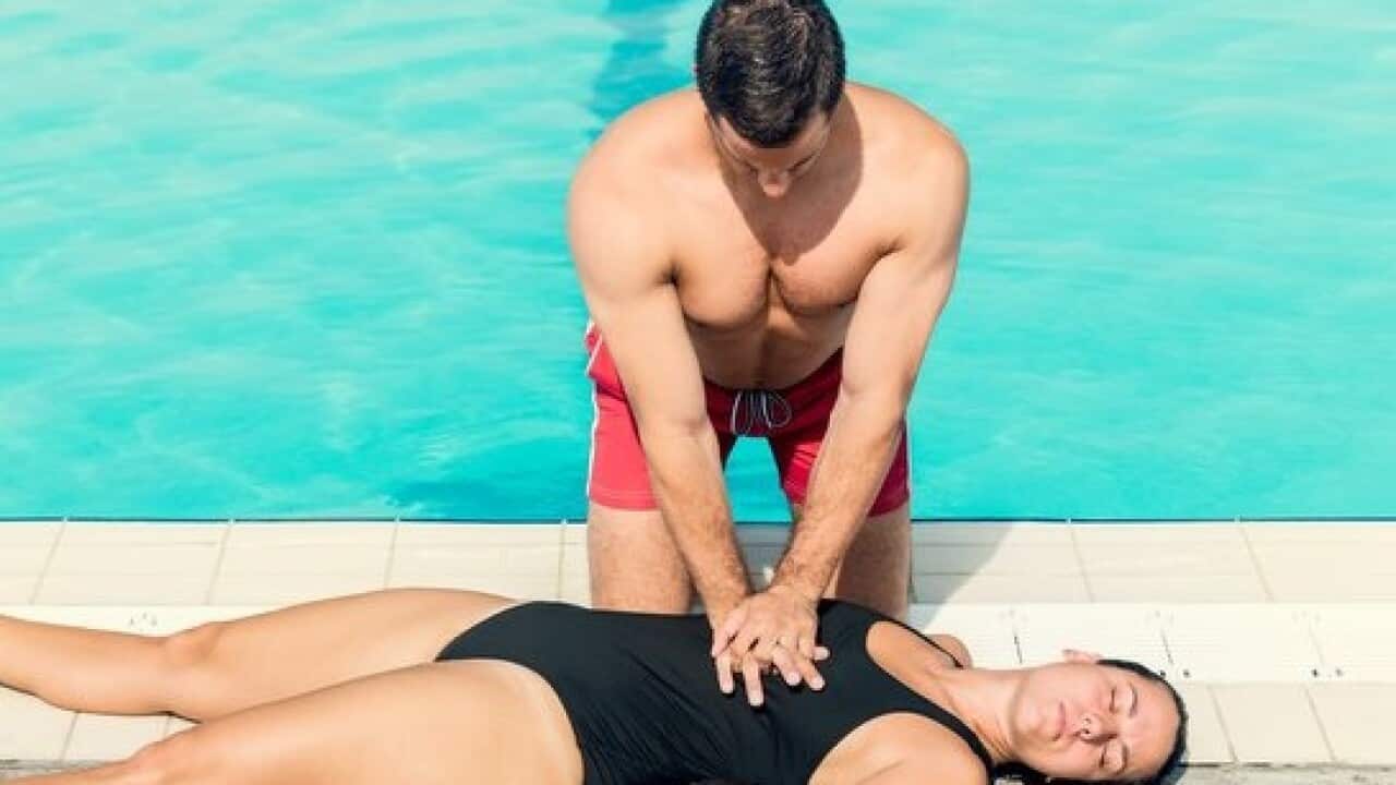 Lifeguard doing resuscitation procedure