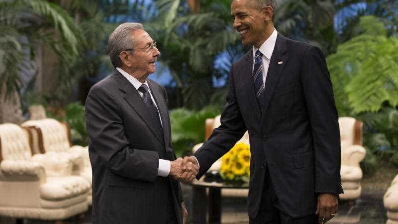 Cuban President Raul Castro, left, shakes hands with US President Barack Obama during a meeting in Revolution Palace.