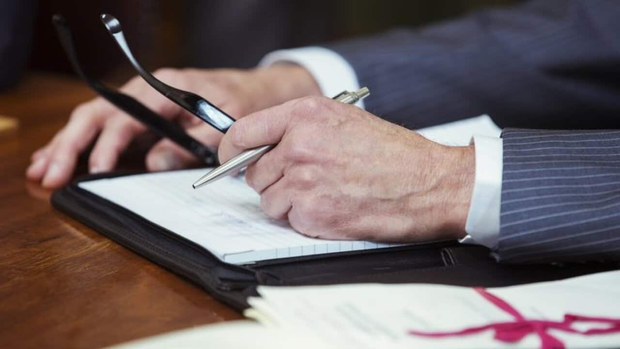 Close up of lawyers hands in courtroom