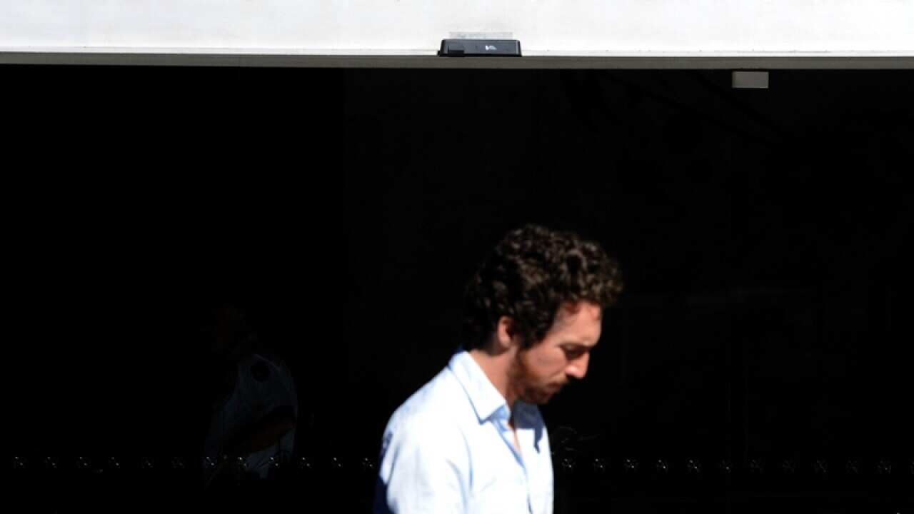 A pedestrian walks past the Reserve Bank of Australia