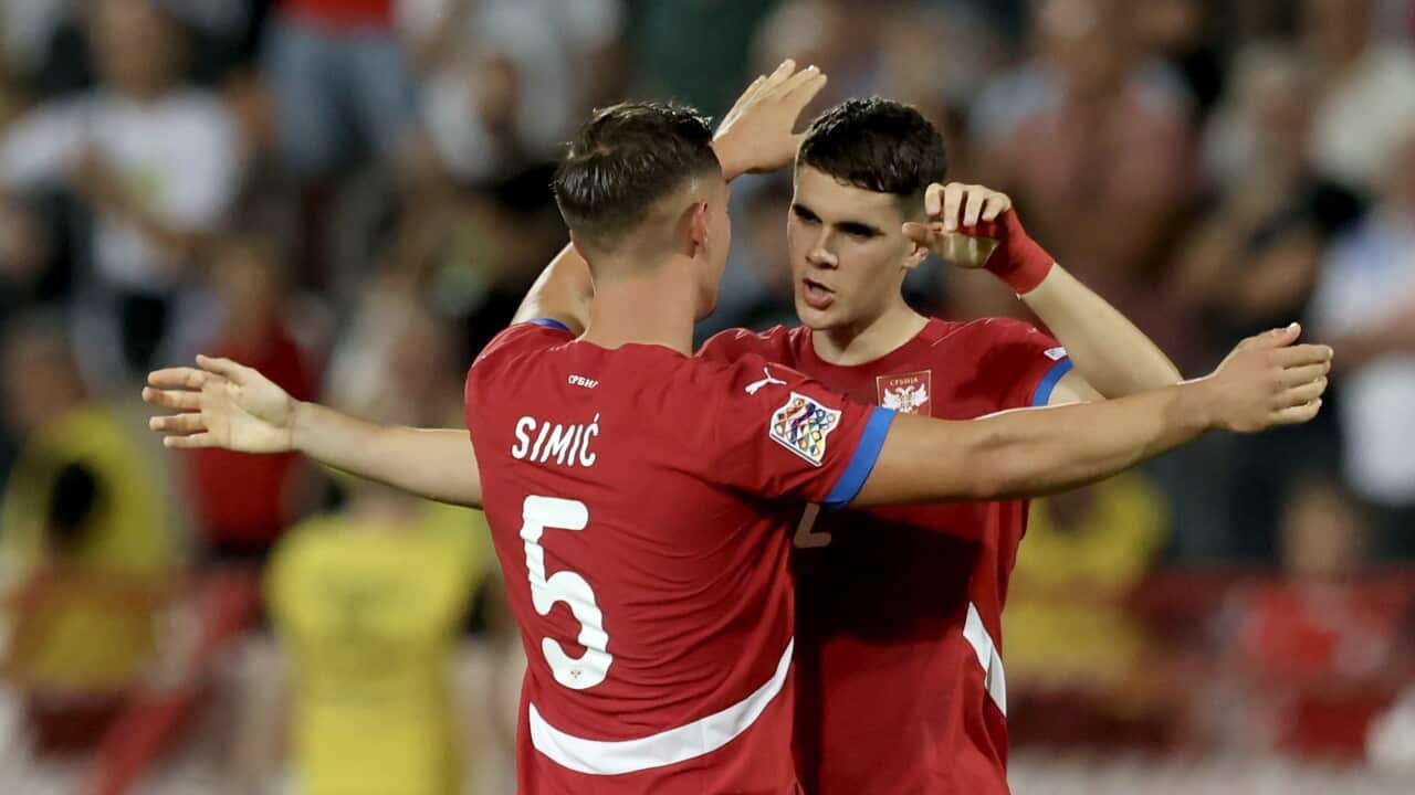 Jan-Carlo Simic (L) and Kosta Nedeljkovic (R) of Serbia congratulate each other after the draw against Spain in the UEFA Nations League football match in Belgrade
