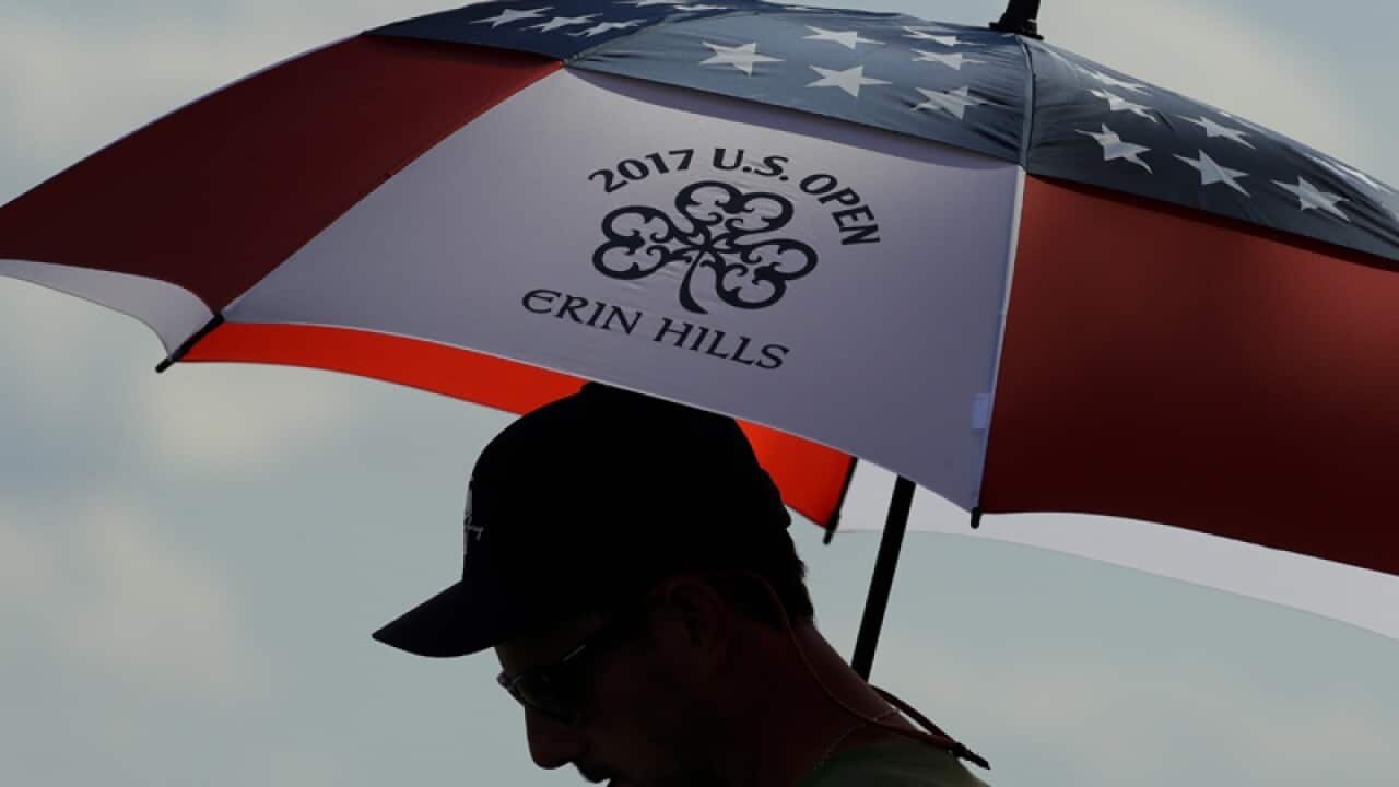 A fan uses an umbrella
