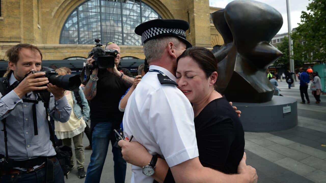 7/7 survivor Gill Hicks hugs PC Andy Maxwell, who came to her aid when she was injured at Kings Cross Station in London nearly 10 years ago