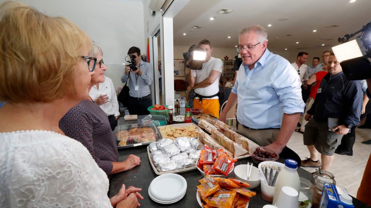 Prime Minister Scott Morrison speaks with volunteers while visiting the relief centre in Lobethal, South Australia, Tuesday, December 24, 2019. The Prime Minister is touring fire affected areas in South Australia. (AAP Image/Kelly Barnes) NO ARCHIVING