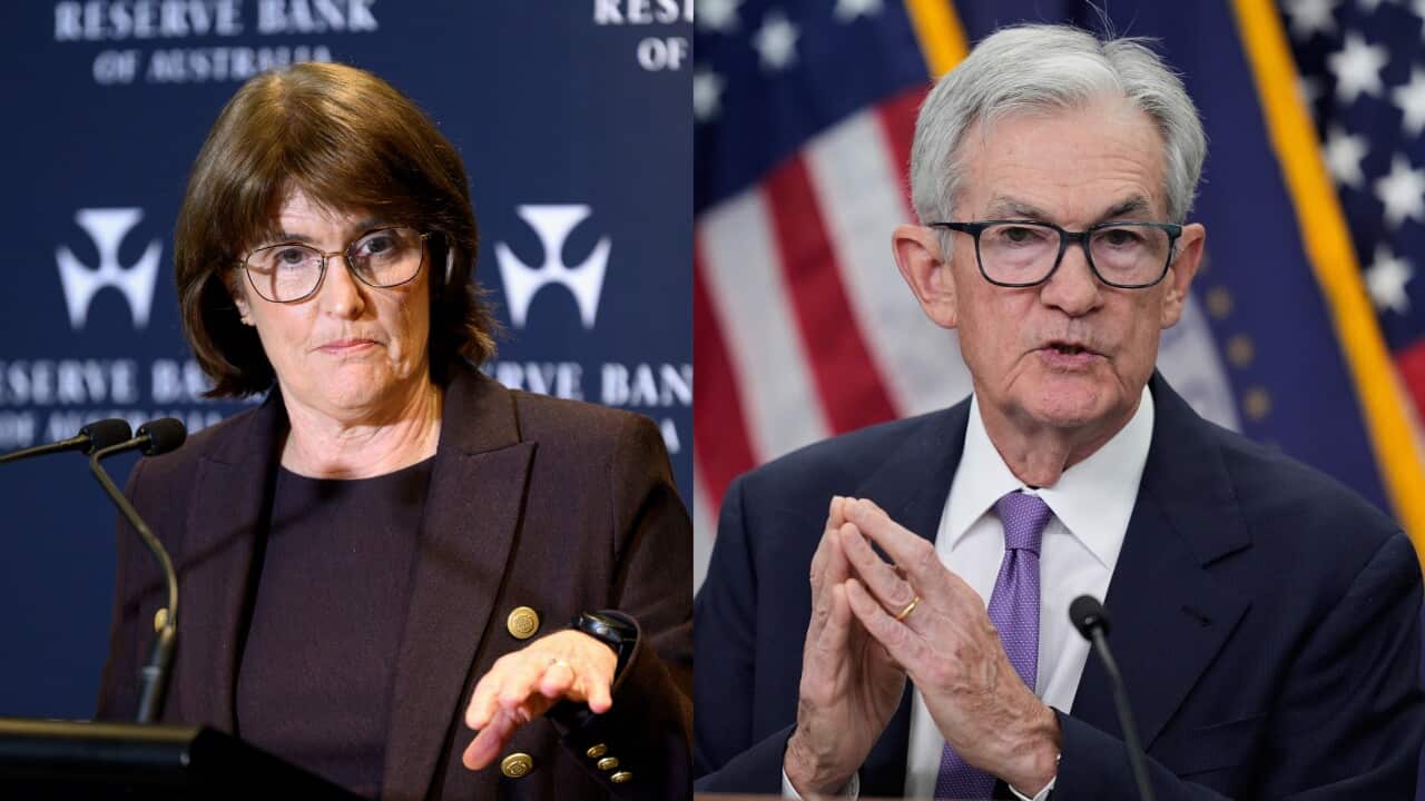 Michele Bullock and Jerome Powell in front of mics.