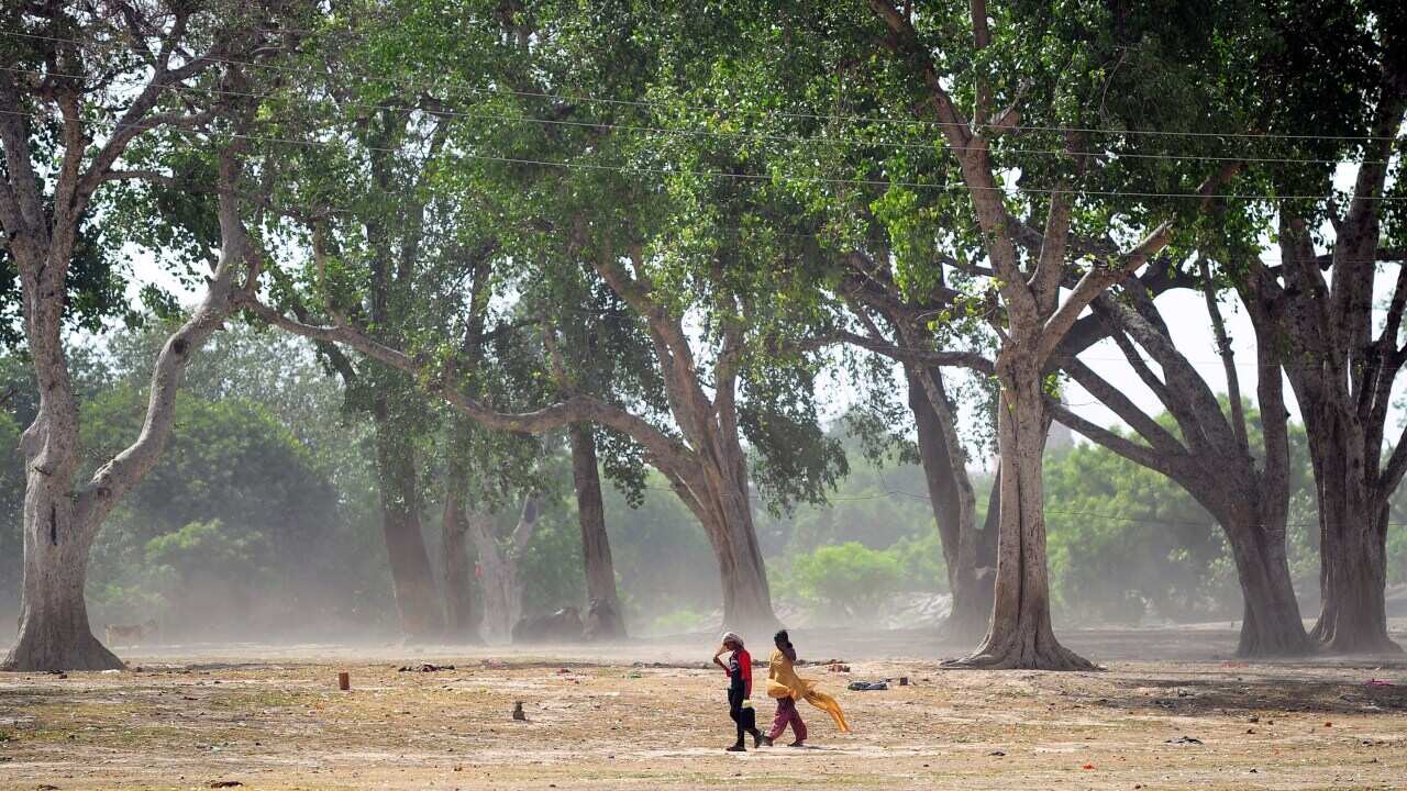 Indian girls walk home during a hot day in Allahabad