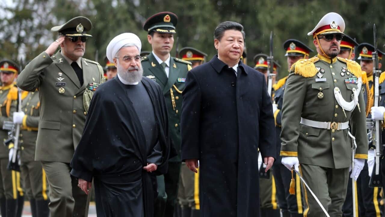 File image: Chinese President Xi Jinping, fourth left, reviews an honor guard as he is welcomed by his Iranian counterpart Hassan Rouhani, second left.