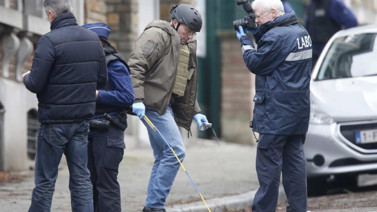 Forensic police officers look for evidence