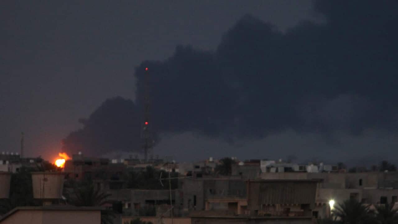 Black smoke billows from a fuel storage depot