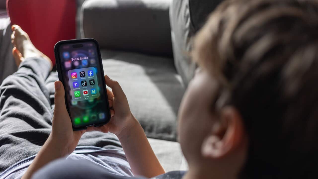 12-year-boy looks at his phone on February 9, 2025 in Bath, England.