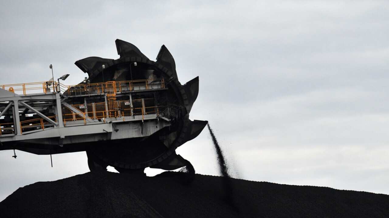 A loader shifts coal